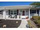 Close up of a welcoming front porch area with comfortable seating and charming decor at 616 Third Ave, Lady Lake, FL 32159