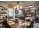 Charming kitchen features a dining table set for dinner and rustic wooden cabinetry at 616 Third Ave, Lady Lake, FL 32159