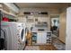 Well-organized laundry room with countertop, storage shelves, front load washer and dryer, and wood-look flooring at 616 Third Ave, Lady Lake, FL 32159