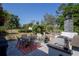 Spacious patio with outdoor kitchen, seating area, and a well-maintained garden at 616 Third Ave, Lady Lake, FL 32159