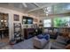 Cozy sunroom with an electric fireplace, tile floors, comfortable seating, and ladder shelves for décor at 616 Third Ave, Lady Lake, FL 32159