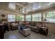Bright sunroom featuring tile floors, neutral paint, many windows, ceiling fans, and comfortable seating at 616 Third Ave, Lady Lake, FL 32159