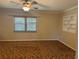 Bedroom featuring a ceiling fan, neutral walls, and a window for natural light at 619 W Seminole Ave, Eustis, FL 32726