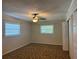 Bedroom showcasing a ceiling fan, and two windows, providing ample natural light at 619 W Seminole Ave, Eustis, FL 32726