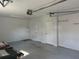 Attached garage with 3 entry doors and concrete floors at 619 W Seminole Ave, Eustis, FL 32726