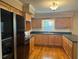 Spacious kitchen with wooden floors, window above sink, and sleek appliances at 619 W Seminole Ave, Eustis, FL 32726