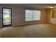 Bright living room featuring a large window, neutral walls, and built-in shelving at 619 W Seminole Ave, Eustis, FL 32726