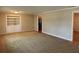 Living room showcasing neutral walls, built-in shelving and access to other rooms at 619 W Seminole Ave, Eustis, FL 32726
