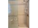 Tiled shower stall featuring a glass door and two built-in soap shelves at 619 W Seminole Ave, Eustis, FL 32726