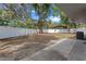 Large backyard featuring a white picket fence providing privacy and mature trees offering shade at 6808 Fern Cir, Leesburg, FL 34748