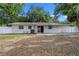 Spacious backyard with fence and mature trees, perfect for outdoor activities and relaxation at 6808 Fern Cir, Leesburg, FL 34748