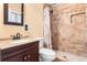 Bathroom boasts tile shower with built-in niche, modern sink, and warm neutral tones at 6808 Fern Cir, Leesburg, FL 34748