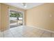 Bright bedroom with sliding glass door and views of the backyard at 6808 Fern Cir, Leesburg, FL 34748