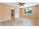 Cozy bedroom with tile floors, ceiling fan, and ample natural light at 6808 Fern Cir, Leesburg, FL 34748
