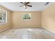 Bright bedroom with neutral walls, ceiling fan, and tile floors at 6808 Fern Cir, Leesburg, FL 34748