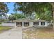 Inviting single-story home with a long driveway and well-maintained lawn at 6808 Fern Cir, Leesburg, FL 34748
