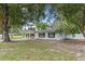 Charming single-story home with a well-maintained lawn and mature shade trees at 6808 Fern Cir, Leesburg, FL 34748