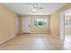 Bright living room with tiled flooring, ceiling fan, and a window with a view at 6808 Fern Cir, Leesburg, FL 34748