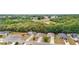 Aerial view of a residential area backing up to a green space and roads at 704 Chelsea Ave, Fruitland Park, FL 34731