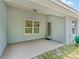 View from covered patio with an exit door to a concrete patio and backyard at 704 Chelsea Ave, Fruitland Park, FL 34731