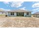 A backyard featuring an expansive yard space with a covered patio, perfect for outdoor entertaining at 704 Chelsea Ave, Fruitland Park, FL 34731