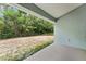 View from covered patio of a private backyard with lush greenery at 704 Chelsea Ave, Fruitland Park, FL 34731