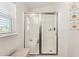 Modern bathroom featuring a glass-enclosed shower and natural light from the window at 704 Chelsea Ave, Fruitland Park, FL 34731