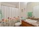 Bathroom featuring granite countertop, and floral shower curtain at 704 Chelsea Ave, Fruitland Park, FL 34731