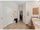 Bathroom with double sinks and neutral-toned floors offers a bright and clean aesthetic at 704 Chelsea Ave, Fruitland Park, FL 34731