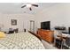 Another angle of this comfortable bedroom with light walls and a ceiling fan at 704 Chelsea Ave, Fruitland Park, FL 34731