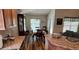 Cozy dining area with wood flooring, natural light, and adjacent to kitchen and living area at 704 Chelsea Ave, Fruitland Park, FL 34731