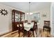 Charming dining room featuring wood flooring, a classic china cabinet, and a lovely chandelier at 704 Chelsea Ave, Fruitland Park, FL 34731