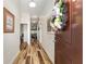 Welcoming foyer with wood flooring, a decorative wreath, and views into the home at 704 Chelsea Ave, Fruitland Park, FL 34731