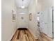 A bright entryway boasting wood floors and a charming floral wreath, creating a welcoming atmosphere at 704 Chelsea Ave, Fruitland Park, FL 34731