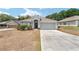 Charming single-story home with a well-manicured front yard, a two-car garage, and a welcoming entrance at 704 Chelsea Ave, Fruitland Park, FL 34731