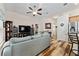 Open concept living area with wood flooring, ceiling fan, and easy access to other living spaces at 704 Chelsea Ave, Fruitland Park, FL 34731