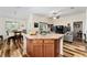 Open living space showcasing a dining area, living room, and kitchen island for seamless entertaining at 704 Chelsea Ave, Fruitland Park, FL 34731