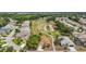 Aerial view of a community home backing onto a lush green golf course with pond at 705 Grand Vista Trl, Leesburg, FL 34748