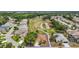 Aerial view of a community home backing onto a lush green golf course with pond at 705 Grand Vista Trl, Leesburg, FL 34748