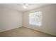 Bedroom showcasing a window with decorative lace curtains and a ceiling fan at 705 Grand Vista Trl, Leesburg, FL 34748