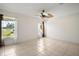 Bright bedroom with a ceiling fan, neutral walls, and tile floors at 705 Grand Vista Trl, Leesburg, FL 34748