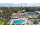 Enjoy this clubhouse with a pool, lounge chairs, and tennis courts for outdoor activities and community engagement at 705 Grand Vista Trl, Leesburg, FL 34748