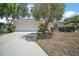 Charming one-story home with an attached garage, well-kept lawn and mature trees at 705 Grand Vista Trl, Leesburg, FL 34748