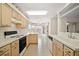 Efficient kitchen with ample counter space, neutral cabinets, and bright lighting at 705 Grand Vista Trl, Leesburg, FL 34748