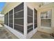 A portion of a screen enclosed lanai and the exterior wall with window of a home at 705 Grand Vista Trl, Leesburg, FL 34748