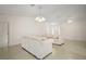 Comfortable living room with tile flooring and neutral decor, showcasing the home's bright interior at 705 Grand Vista Trl, Leesburg, FL 34748