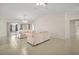 Spacious living room featuring tile flooring, ceiling fan, chandelier, and neutral décor at 705 Grand Vista Trl, Leesburg, FL 34748