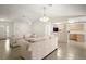 Bright living room providing seamless flow into the adjacent kitchen area at 705 Grand Vista Trl, Leesburg, FL 34748
