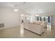 Open living room featuring tile flooring, a ceiling fan, and sliding glass doors to the lanai at 705 Grand Vista Trl, Leesburg, FL 34748
