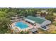 Aerial view of a community pool with several tables and lounge chairs at 705 Grand Vista Trl, Leesburg, FL 34748